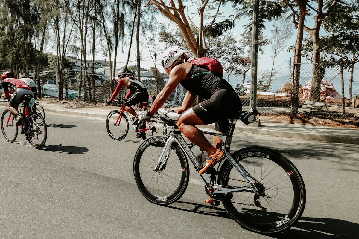 A Man Biking on a Road
