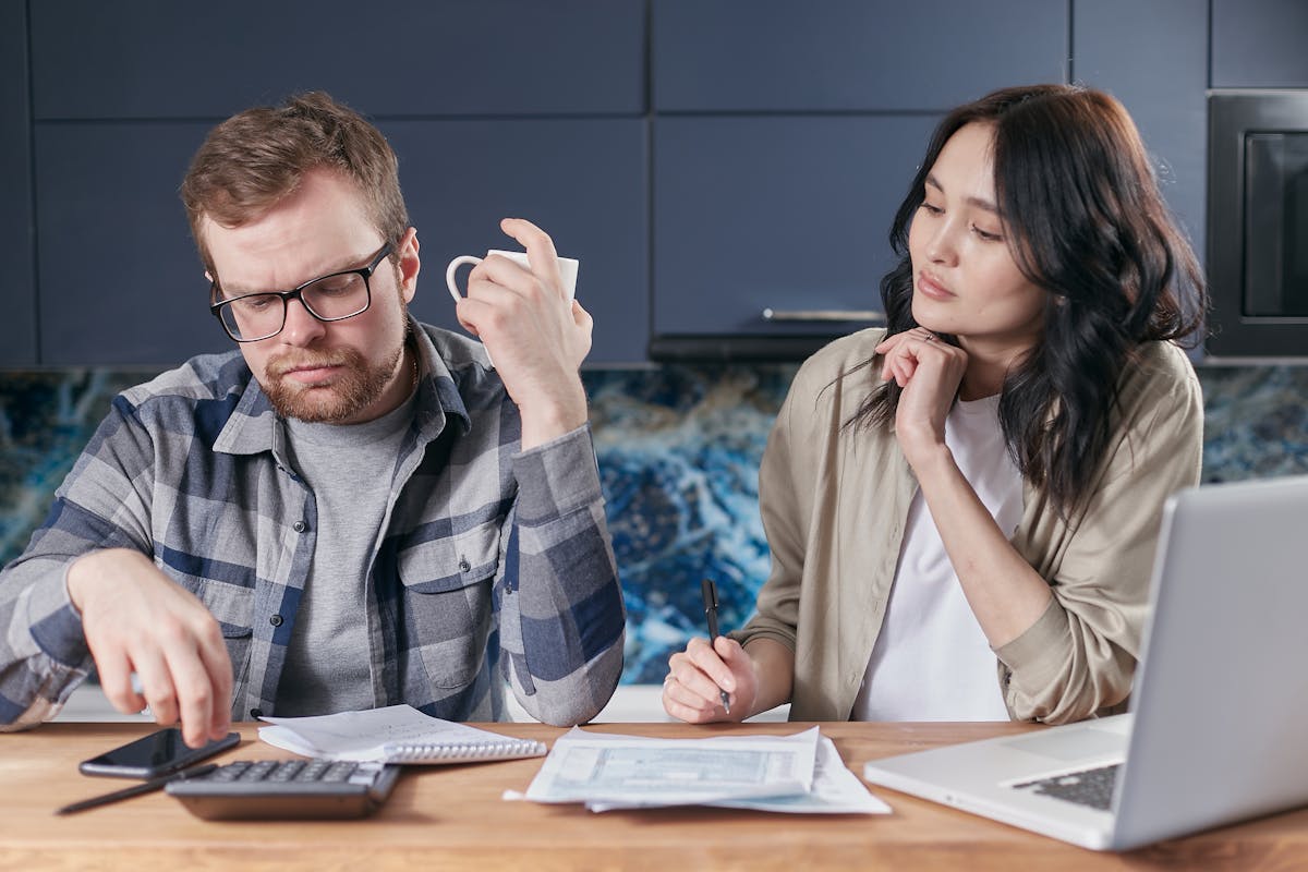 A focused young couple reviewing document